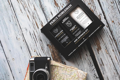 Percy Nobleman Age Defence Kit, a men's skincare set containing Charcoal Face Scrub (with Natural AHAs), ultra-hydrating Facial Serum (with Hyaluronic Acid), and Moisturiser (with Vitamin C)